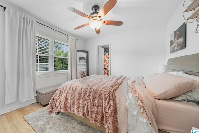 bedroom with light wood-type flooring and ceiling fan