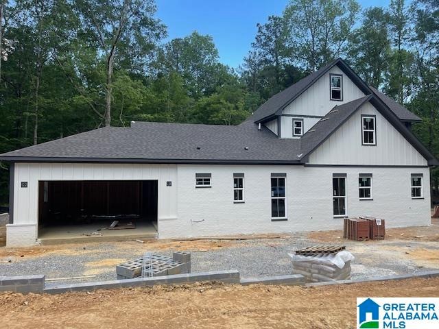 rear view of property featuring a garage