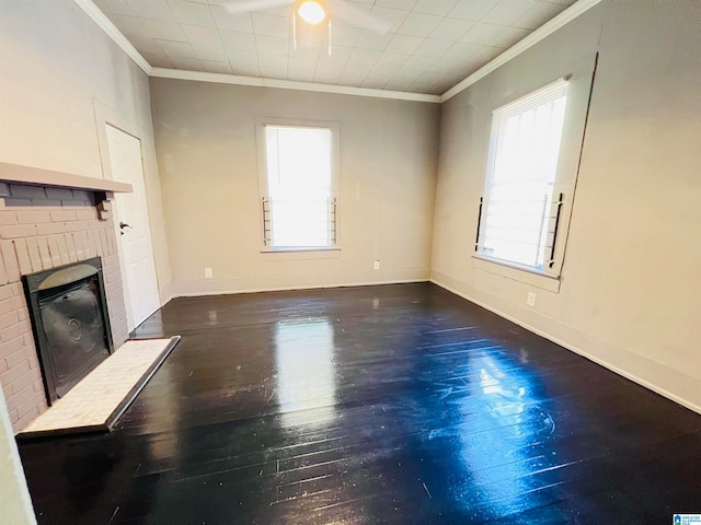 unfurnished living room featuring crown molding, ceiling fan, dark hardwood / wood-style floors, and a fireplace