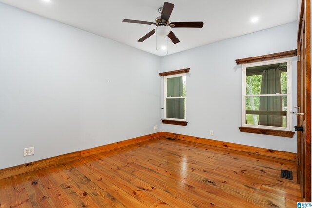 spare room featuring light hardwood / wood-style flooring and ceiling fan