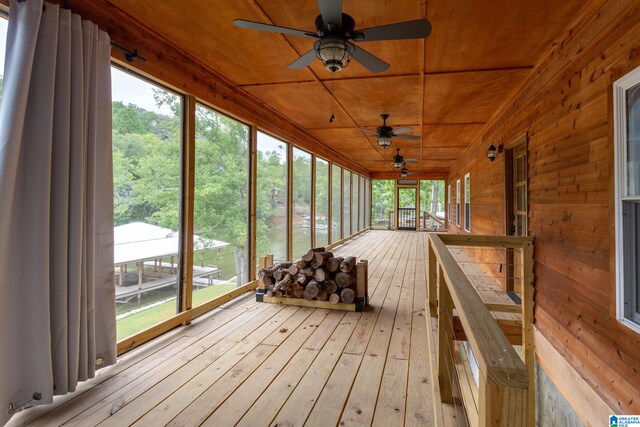 unfurnished sunroom featuring wooden ceiling, vaulted ceiling, and ceiling fan