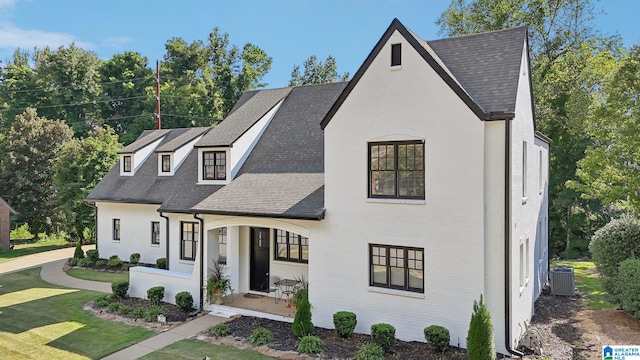 view of front of home featuring a front yard and cooling unit