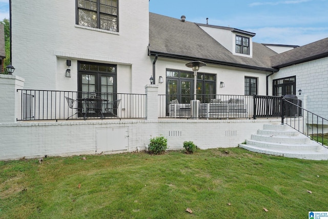 rear view of house featuring a lawn