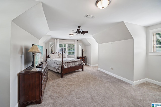 bedroom with ceiling fan, lofted ceiling, light carpet, and multiple windows