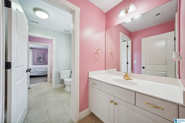 bathroom featuring tile patterned floors, vanity, and toilet