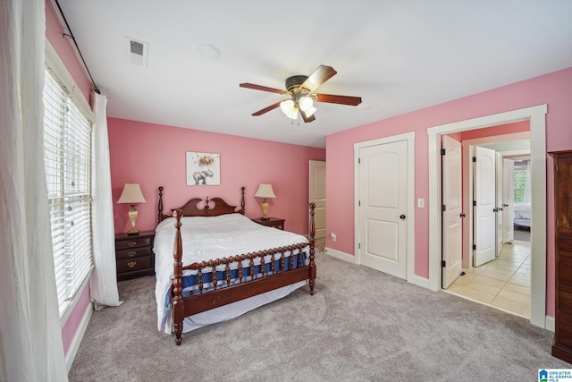 bedroom featuring ceiling fan and light colored carpet