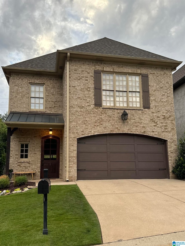 view of front of property featuring a front yard and a garage