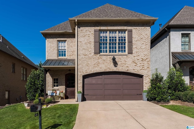 view of front of property with a front lawn and a garage