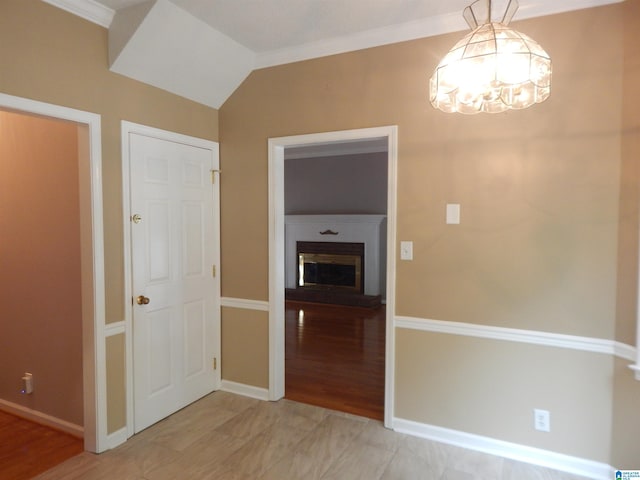 hallway with crown molding, light hardwood / wood-style flooring, vaulted ceiling, and a chandelier