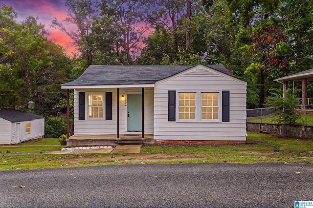 view of front of house with a porch and an outdoor structure