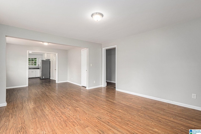 spare room featuring dark wood-type flooring