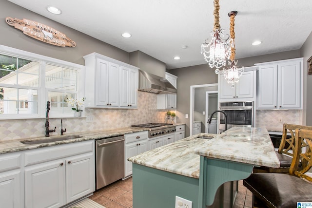 157 Hickory Ridge Dr, Glencoe, AL 35905 - kitchen featuring appliances with stainless steel finishes, a sink, wall chimney exhaust hood, white cabinets, and recessed lighting