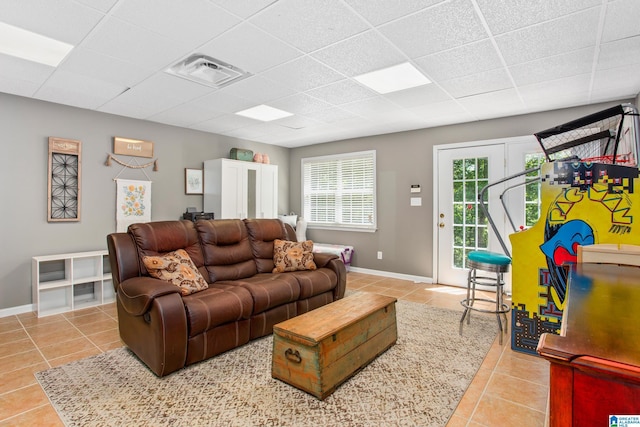 157 Hickory Ridge Dr, Glencoe, AL 35905 - living room featuring tile patterned flooring, a paneled ceiling, and baseboards