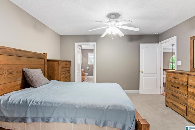 157 Hickory Ridge Dr, Glencoe, AL 35905 - bedroom with light carpet, baseboards, a ceiling fan, connected bathroom, and a textured ceiling