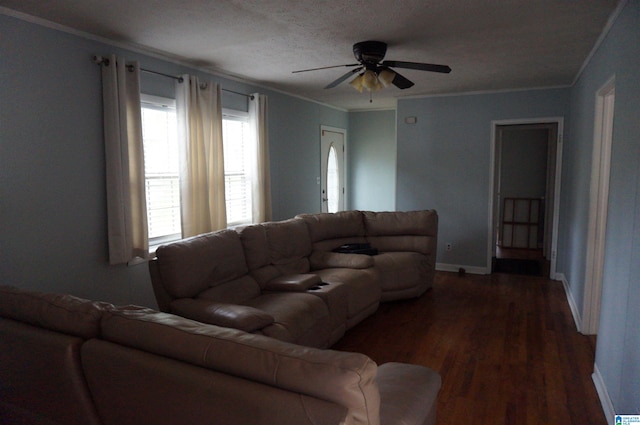 living room featuring ceiling fan, dark hardwood / wood-style flooring, crown molding, and a textured ceiling