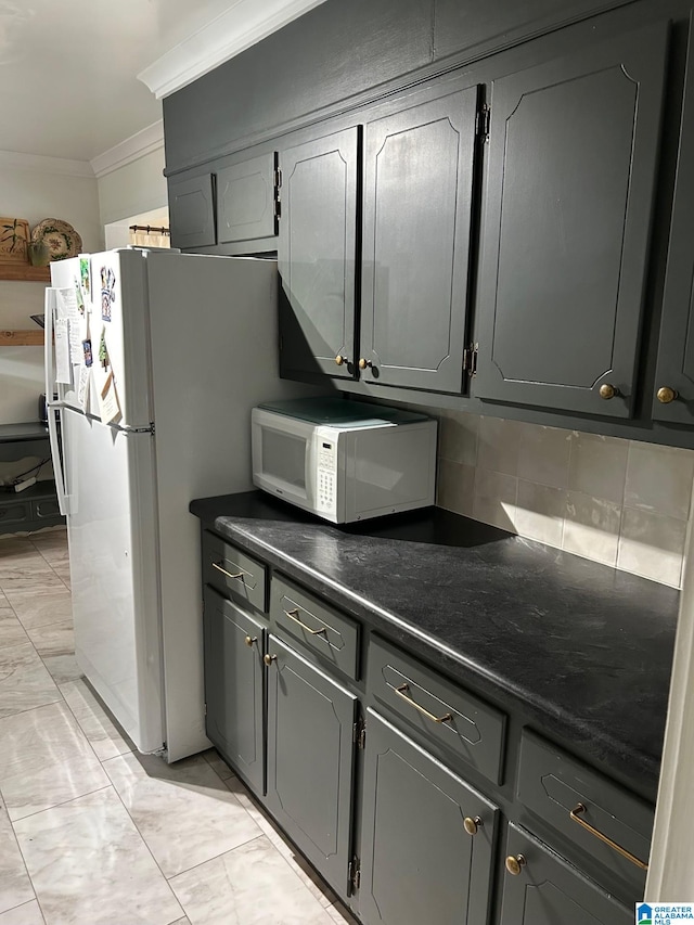 kitchen with gray cabinetry, decorative backsplash, white appliances, and ornamental molding