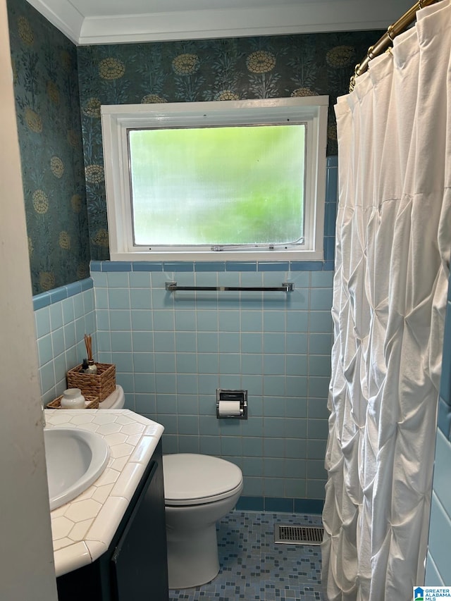 bathroom with vanity, crown molding, tile walls, tile patterned flooring, and curtained shower