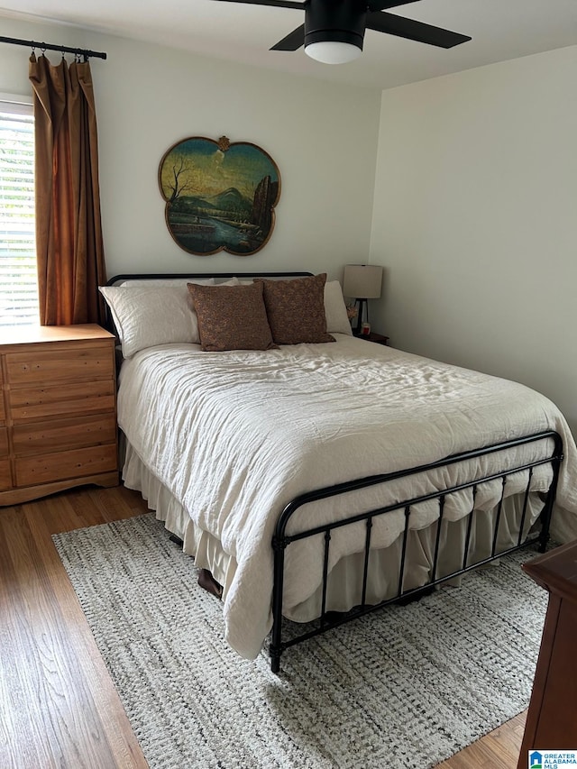 bedroom featuring ceiling fan and hardwood / wood-style flooring