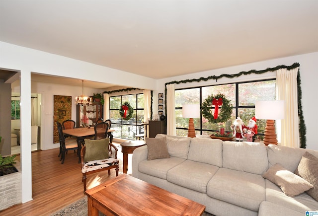 living room featuring hardwood / wood-style floors and a notable chandelier