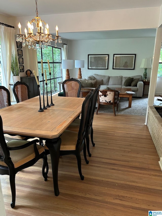 dining room with hardwood / wood-style flooring and an inviting chandelier