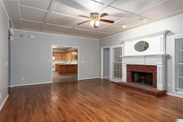 unfurnished living room featuring sink, coffered ceiling, a fireplace, dark hardwood / wood-style flooring, and ceiling fan