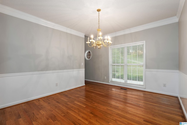 unfurnished room featuring crown molding, an inviting chandelier, and hardwood / wood-style flooring