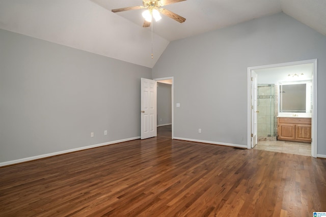 unfurnished bedroom featuring dark hardwood / wood-style floors, ensuite bath, ceiling fan, and high vaulted ceiling