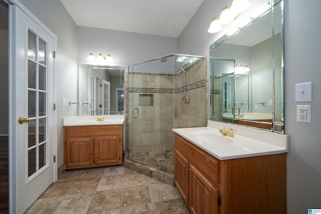 bathroom with vanity and a shower with door