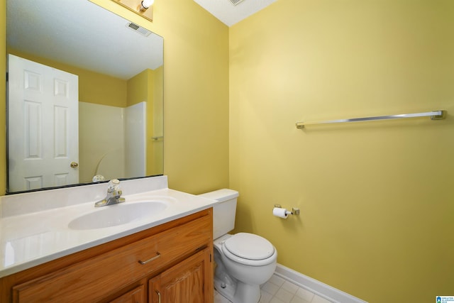 bathroom with vanity, toilet, and tile patterned floors