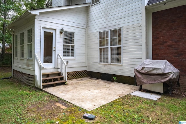 view of exterior entry featuring a patio