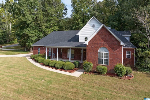 view of front of home featuring covered porch and a front yard