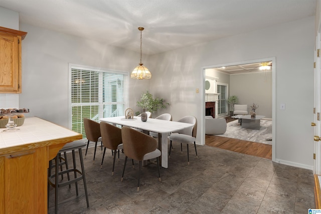 dining room featuring a fireplace and dark hardwood / wood-style flooring