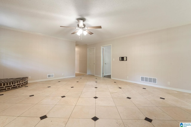 unfurnished room with ceiling fan, a textured ceiling, crown molding, and light tile patterned floors