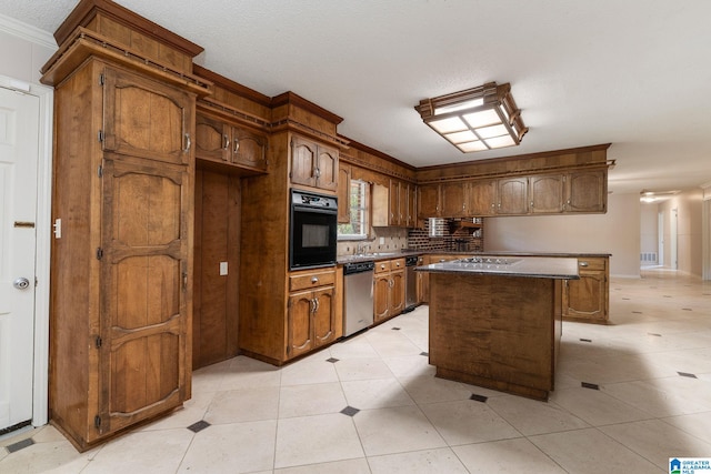 kitchen featuring a center island, dark countertops, black oven, dishwasher, and brown cabinetry