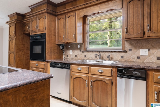 kitchen featuring a sink, black appliances, brown cabinets, and tasteful backsplash