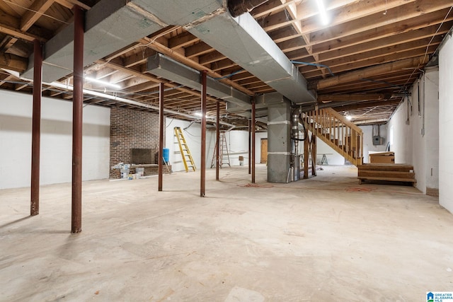 basement featuring a brick fireplace