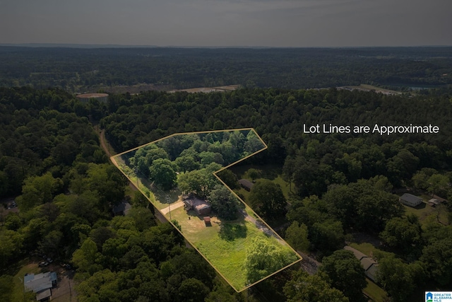 drone / aerial view featuring a forest view