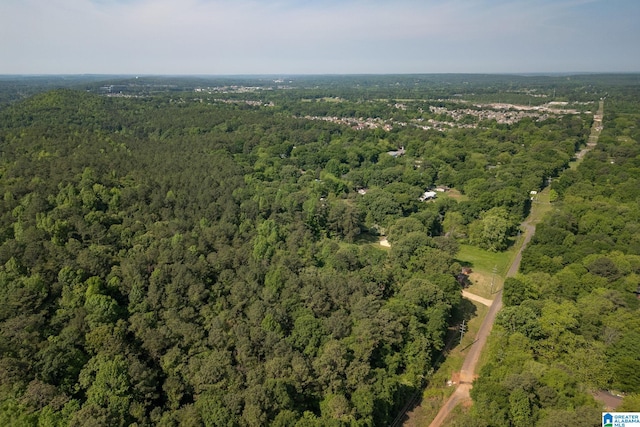 drone / aerial view with a wooded view