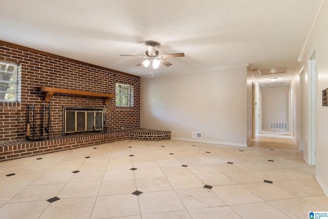 unfurnished living room with a textured ceiling, visible vents, a brick fireplace, and brick wall