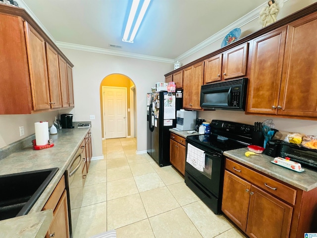 kitchen with black appliances, crown molding, sink, and light tile patterned floors