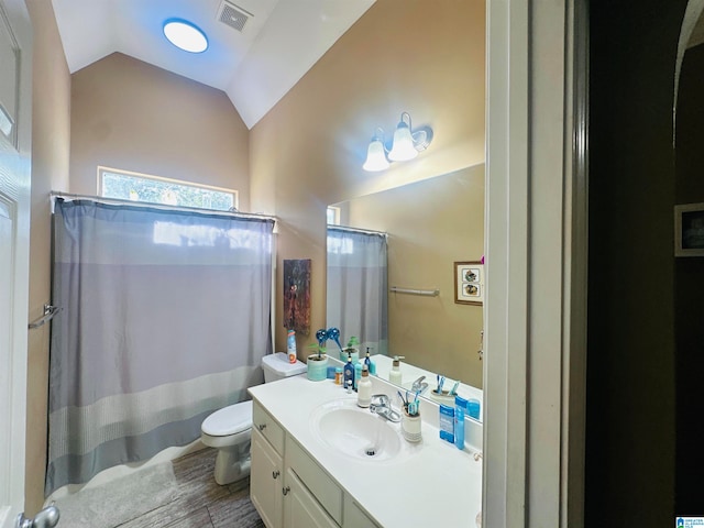 bathroom with vanity, lofted ceiling, hardwood / wood-style flooring, walk in shower, and toilet