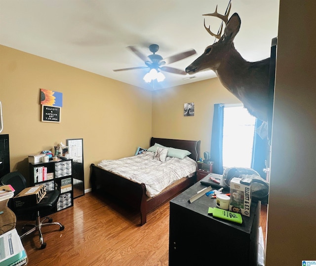 bedroom with hardwood / wood-style floors and ceiling fan