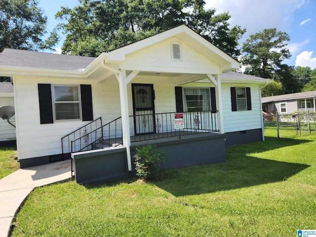 view of front of home with a front yard and a porch