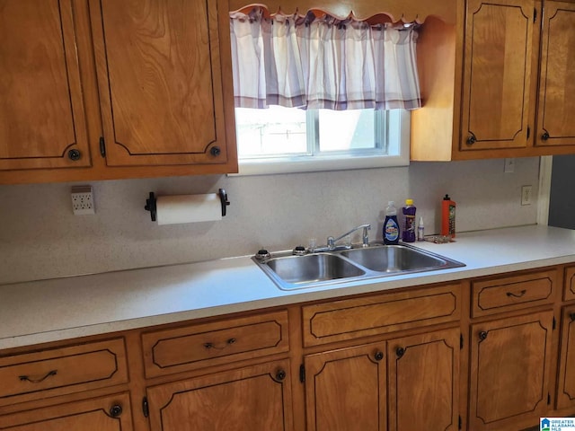 kitchen featuring sink and tasteful backsplash