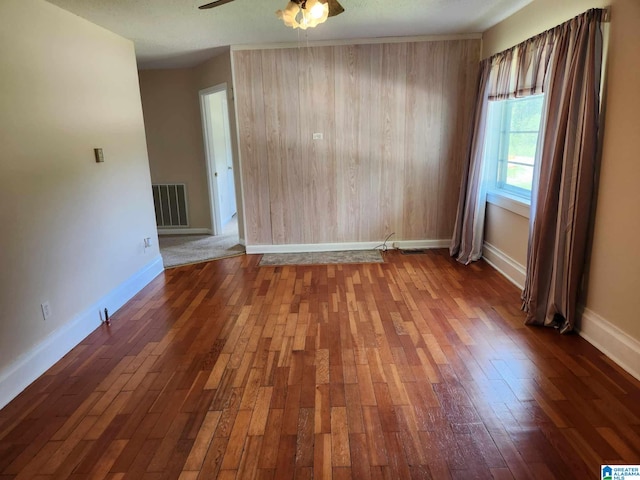 spare room featuring dark hardwood / wood-style flooring and ceiling fan