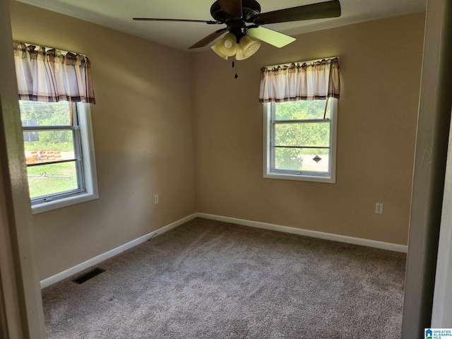 carpeted spare room with ceiling fan