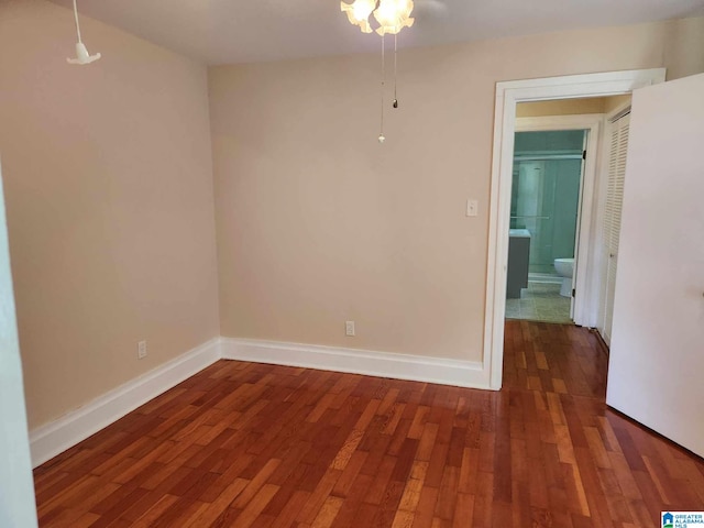 unfurnished room featuring ceiling fan and dark hardwood / wood-style floors