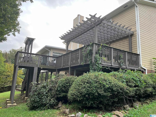 rear view of house with a deck and a pergola