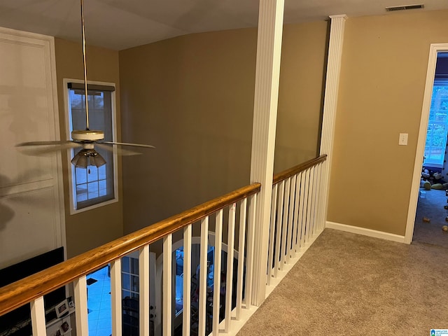 corridor featuring vaulted ceiling and carpet