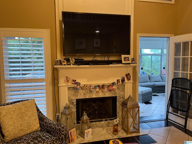 tiled living room with a premium fireplace and plenty of natural light